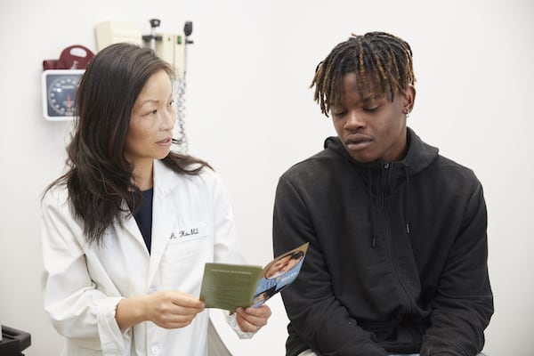 A doctor and patient reviewing a form